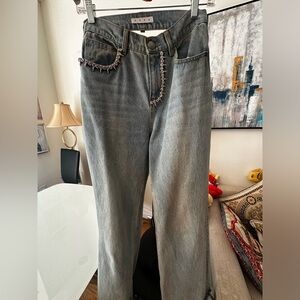 Area denim pants with jeweler chain on the back